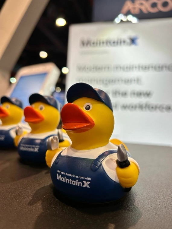 MaintainX rubber duck mascots at an event booth